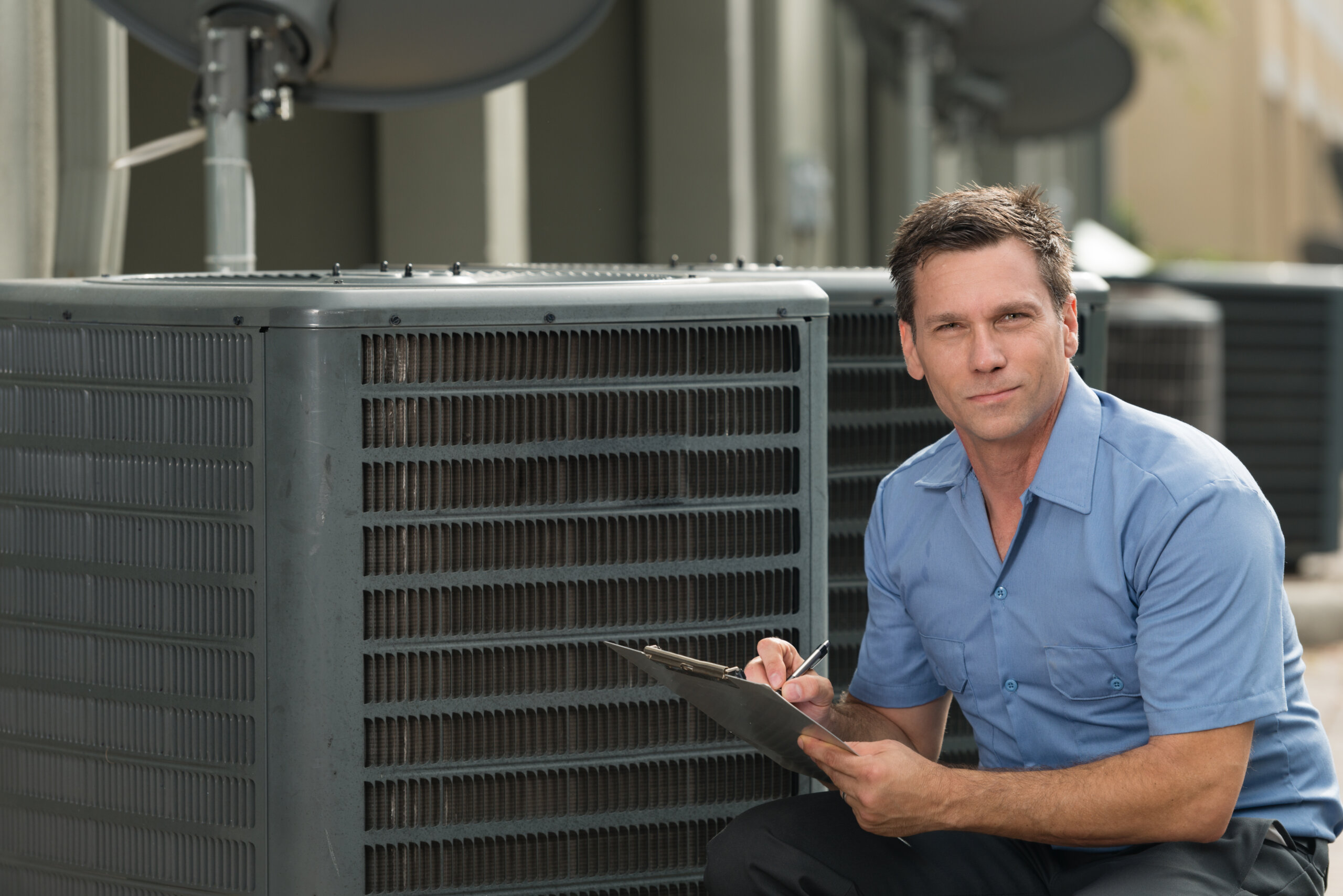 ac technician next to ac unit
