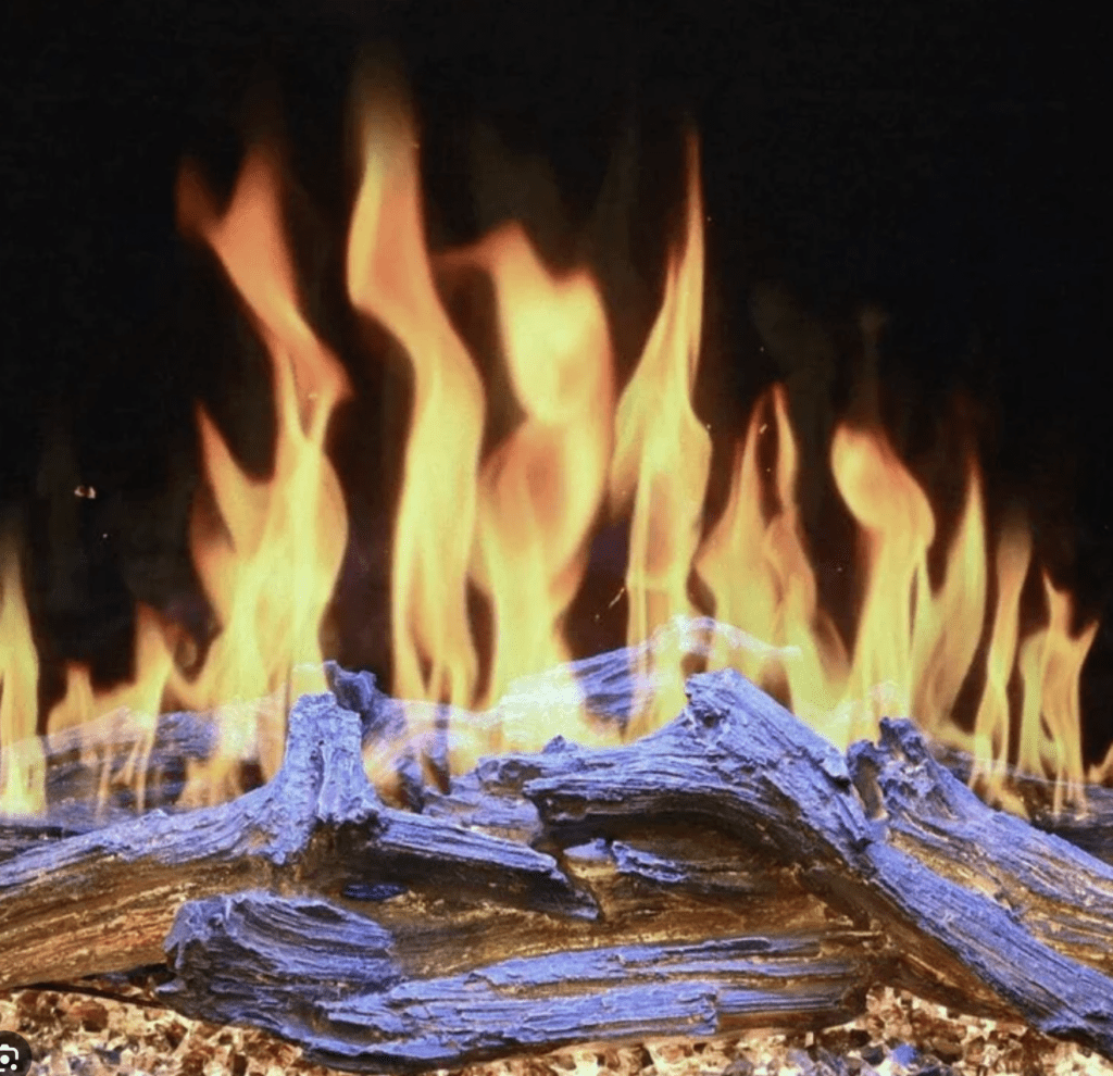 closeup photo of an electric fireplace with driftwood logs and tall fllames